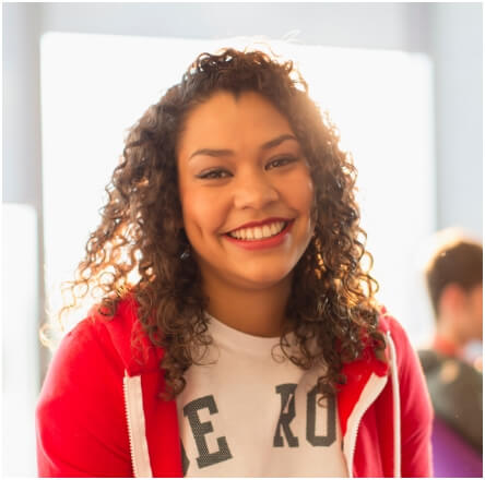 A woman in a red jacket smiling